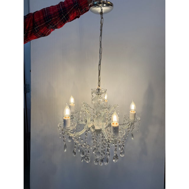 Design Plus Gallery presents a Crystal Chandelier. Transform your space with this dazzling glam chandelier. It has crystal...