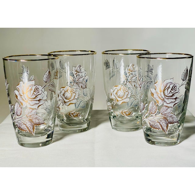 A set of white and gold rose patterned tumblers made by the Libbey Glass Company. Measures 5 1/4 inches tall, 2 inches...