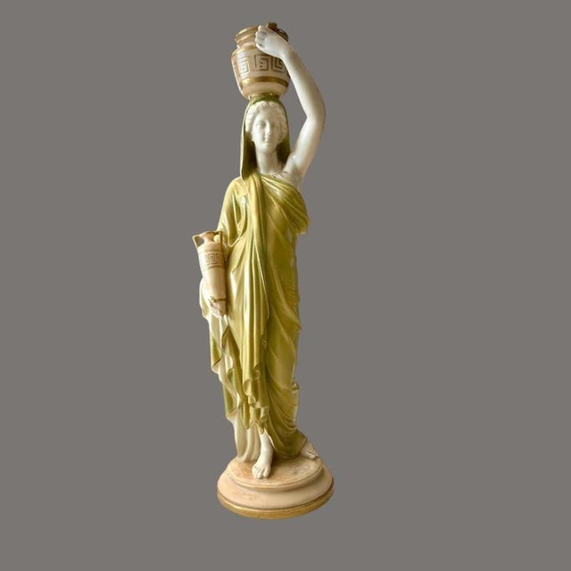 An impressive Royal Worcester porcelain figure depicting a classical maiden or water bearer, dating to the late Victorian...