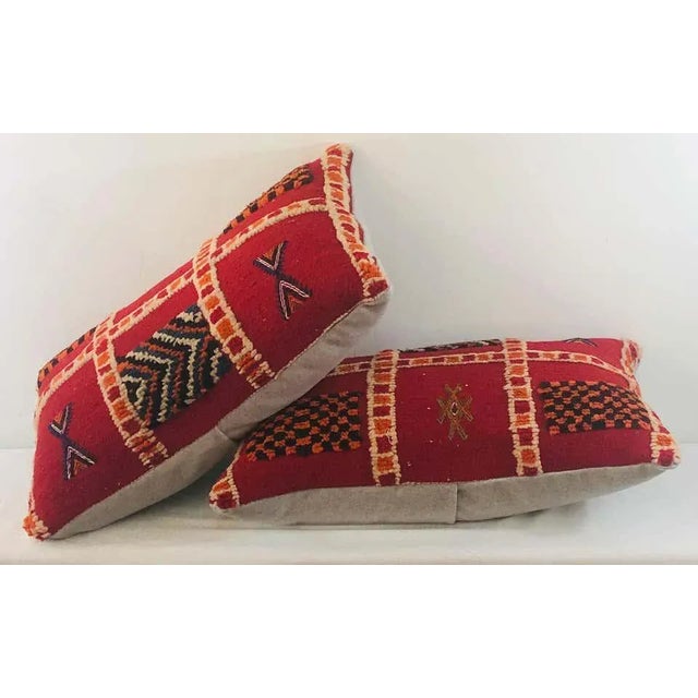 Featuring vivid and earthy burgundy, blue, off white and green colors, this stunning one-of-a-kind pair of Kilim pillows...