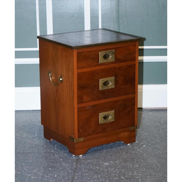 Military campaign bedside nightstand end table. It has brass fittings and traditional brass handles. The top is inlaid...