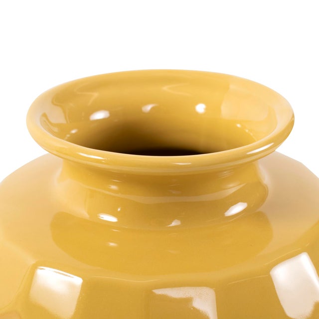 A stunning piece from our collection featuring a honeycomb-designed texture. With its rich golden yellow color, this vase...