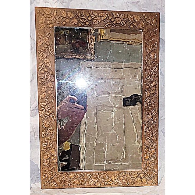 Nouveau hints in this antique wooden American wall mirror, leaf and vine motif with the original wavy floated mirror glass...