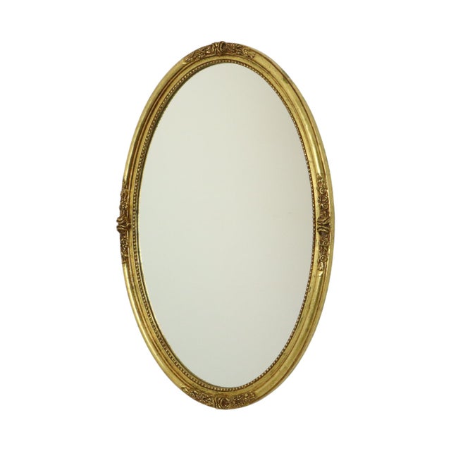 Hollywood Regency oval mirror by Deknudt, made of gold-colored resin, cast resin, with a red undertone, 1960s-70s,...