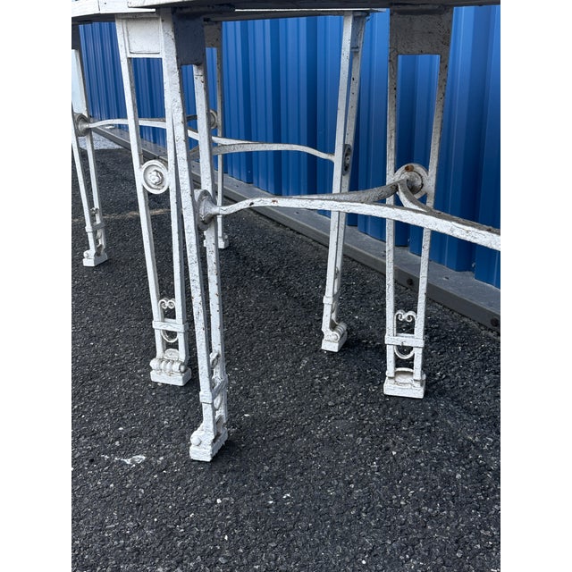 Stately, very heavy, painted white and appears several times. Likely 1910-1920 ornate bases with wood tops, nicely crafted...