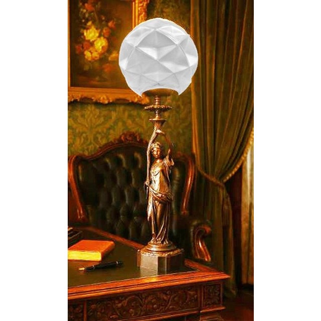 An impressive French figural table lamp dating to circa 1865, featuring a substantial cast-bronze classical female figure...