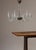 A handblown clear glass chandelier in the Venetian tradition, featuring six scrolling S-curved arms with ruffled bobeches,...