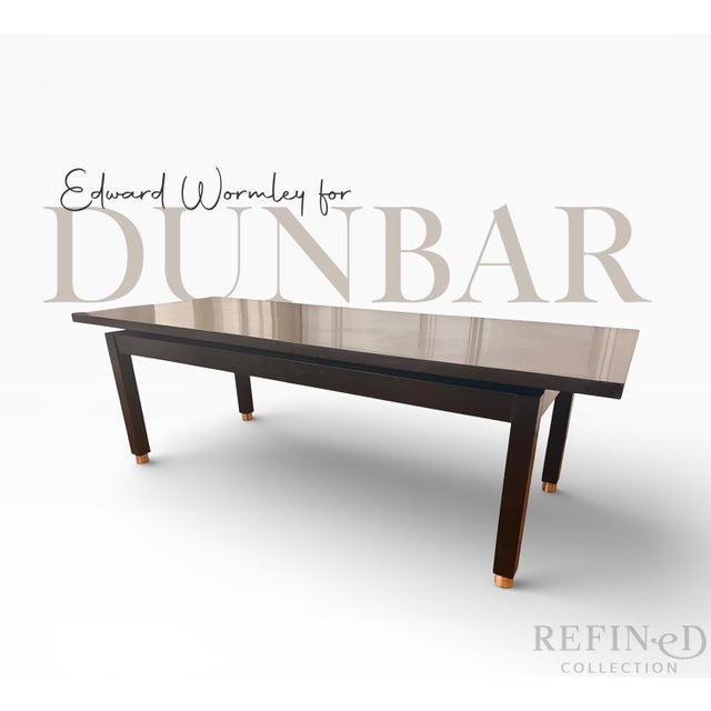 Authentic Edward Wormley for Dunbar mid-century modern coffee table featuring a sleek laminate top and tapered walnut legs...