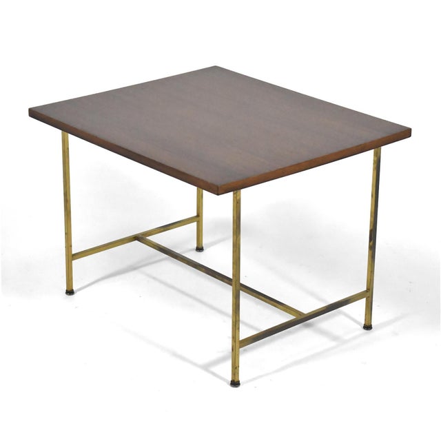 This exquisite vintage example of Paul McCobb's brass base table features a mahogany top and McCobb's elegant design in...
