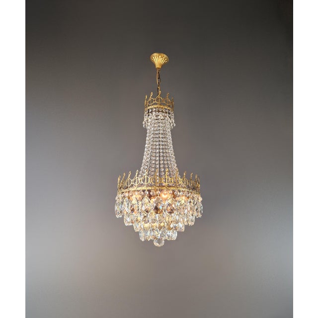 Antique Chandelier with Musical Motif – Empire / Historicism Style An exceptional brass and crystal chandelier featuring...
