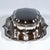 Silver lidded tin on a matching display tray; both items of a curved, elegantly shaped design in the neo-baroque style,...
