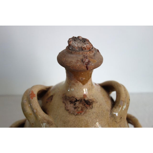 Provençal pottery - a glazed terracotta jug known as a "conscience" jug, dating from the 19th century. This rare model...