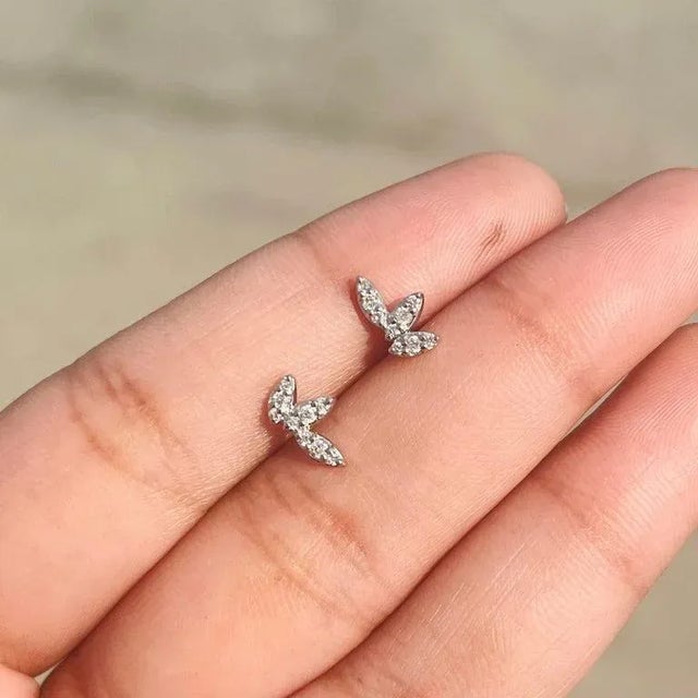This is part of Chairish’s Fine Jewelry assortment. Dainty Diamond Leaf Earrings in 18K Gold to make a statement with your...