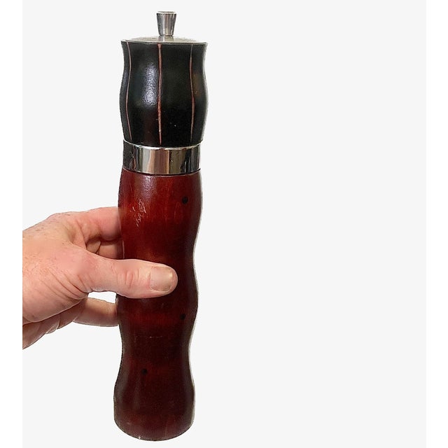 A lathe-turned wooden pepper mill grinder designed and fabricated by American studio artisan Robert Wilhelm. This...