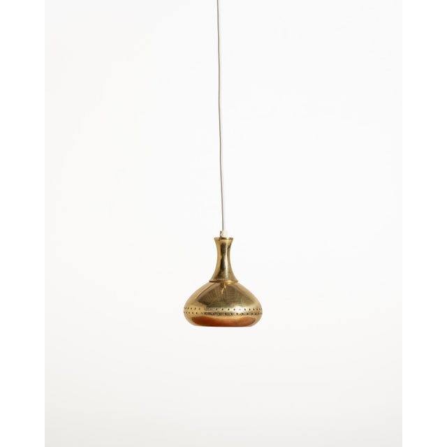 Small brass pendant lamp with a curved shade and a double band of circular perforations. Made by scandi-lamp aps, denmark,...