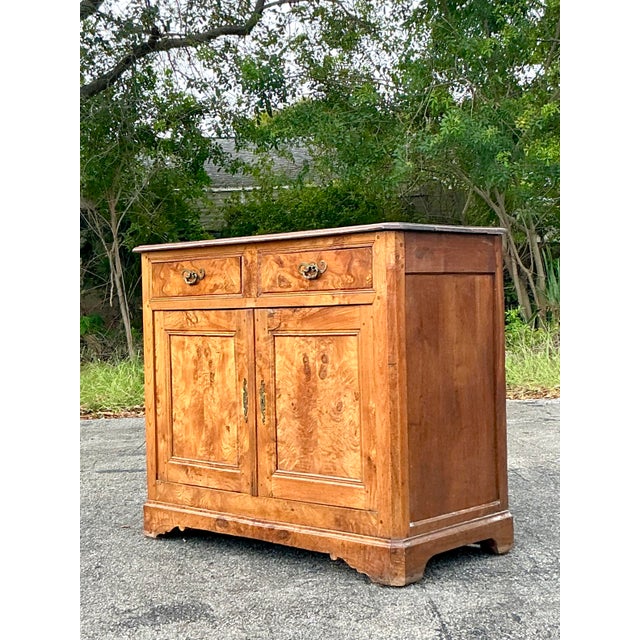 This exquisite 19th-century burl wood sideboard embodies timeless craftsmanship with its rich wood grain, warm patina, and...