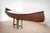 On the basis of an industrial workshop base in cast iron, mounted on a roulette, firmly rests a Canadian canoe,...