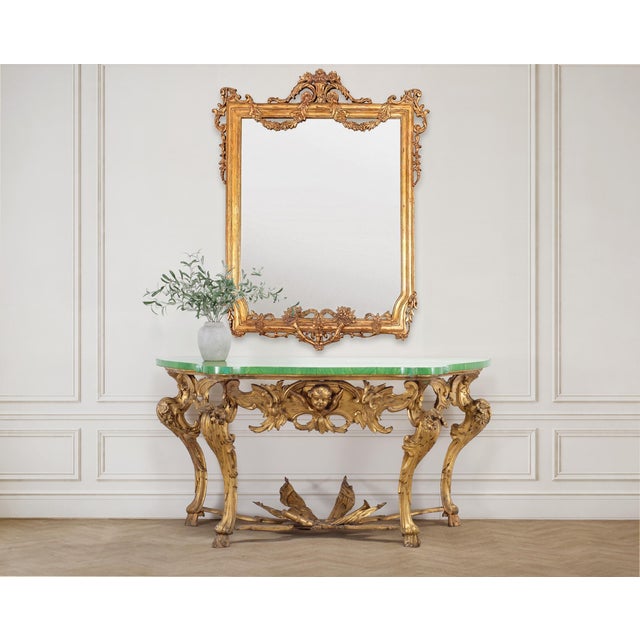 An elegant 18th century giltwood console or pier table crafted in the Italian Rococo period. The distinctive table...