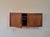 Rival Wall-Mounted Teak Storage Unit, 1960s, in Very Good conditions. Designed 1960 to 1969 This piece has an attribution...