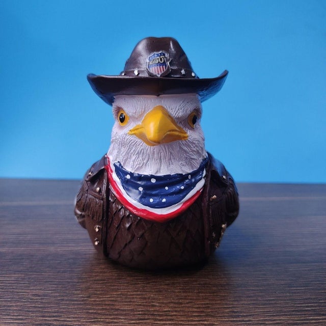 This charming resin figurine features a patriotic bald eagle bust styled with a Western flair. The eagle wears a brown...
