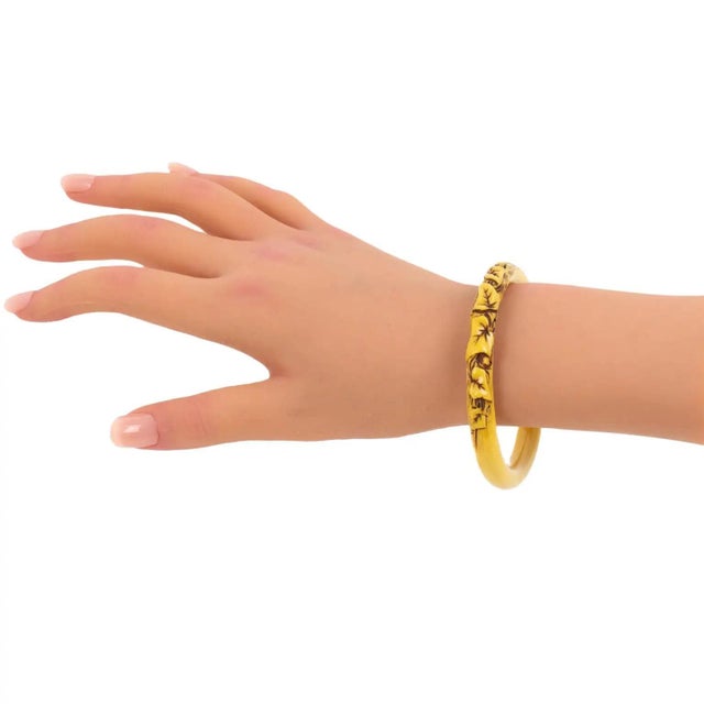 This stunning, rare Art Deco celluloid bracelet bangle features a floral design with deeply carved and stained ivy leaves....