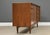A mid century modern teak sideboard credenza with twelve dovetail dresser drawers by Falster. Sliding tambour door that...