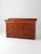 A late 19th-century antique wood dry sink with a deep inset top above a two-door cabinet, featuring vertical paneled...