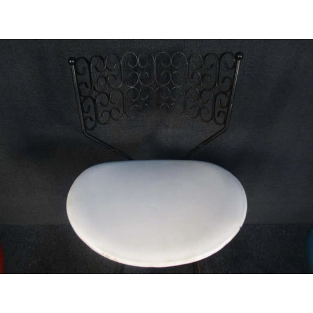 With contrasting colors of vinyl seat coverings, these vintage stools feature metal backs with playful decorative...