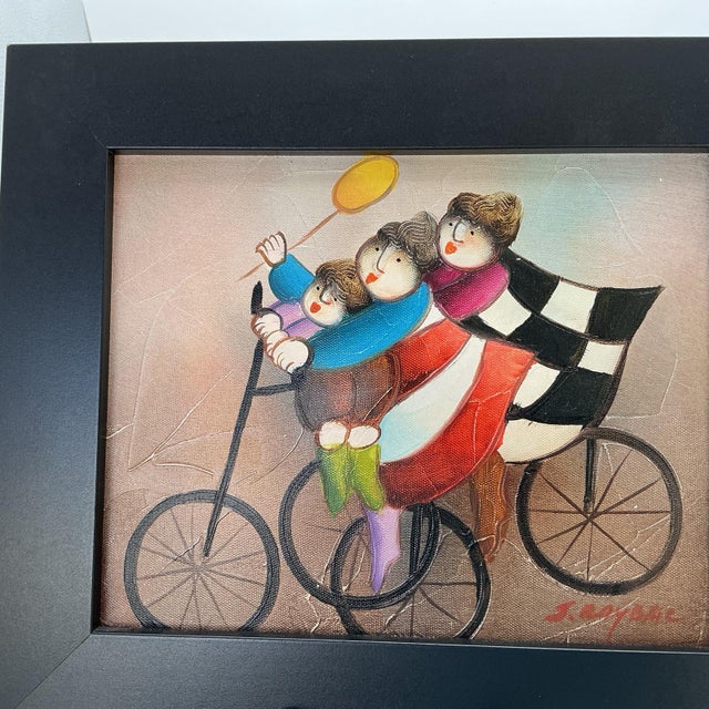 Charming original oil painting by Joyce Roybal depicting whimsical cyclists in the artist’s distinctive folk-art style....