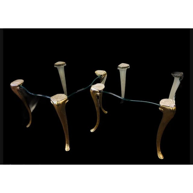 Square elegant bronze and glass side tables by Maison Charles. The tables have bevelled, thick glass top. It is supported...