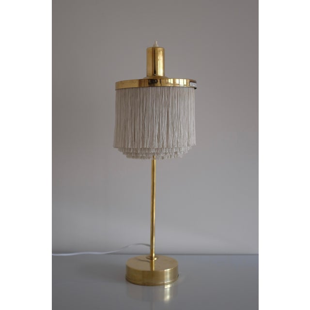 Iconic Fringe and Brass Table Lamp B-140 by Hans Agne Jakobsson. Manufactured in the late 1960s and part of one of Hans...