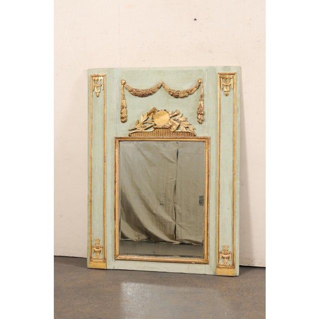 An Italian musical-themed carved and painted wood mirror from the 19th century. This antique mirror from Italy has been...