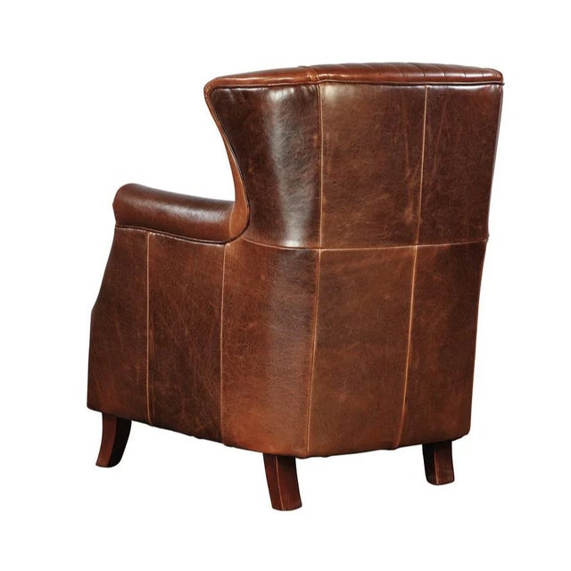 Vintage charm abounds in this well scaled leather wing chair highlighted by distinctive diamond quilting and hand applied...