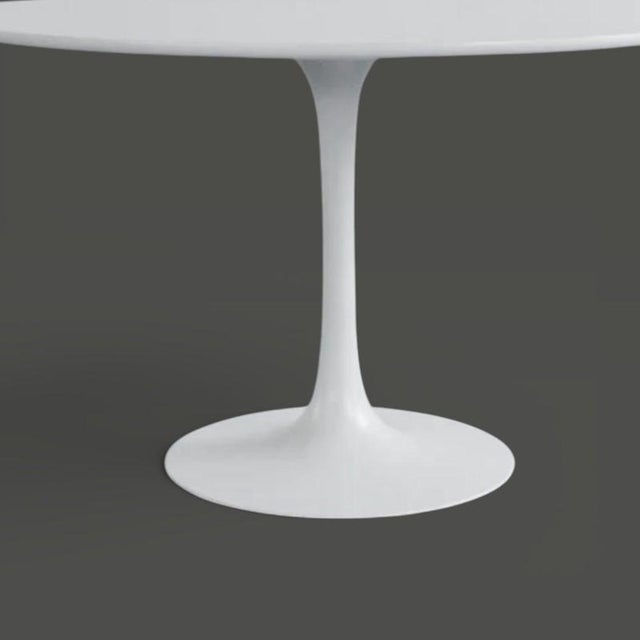 The Tulip dining table is a stunning 1960s design table by Maurice Burke, featuring a white fibreglass dining table top...