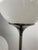 Pair of Lamperti lamps with original opaline glass resting on a ceramic base, steel stem with interlocking cast iron base...