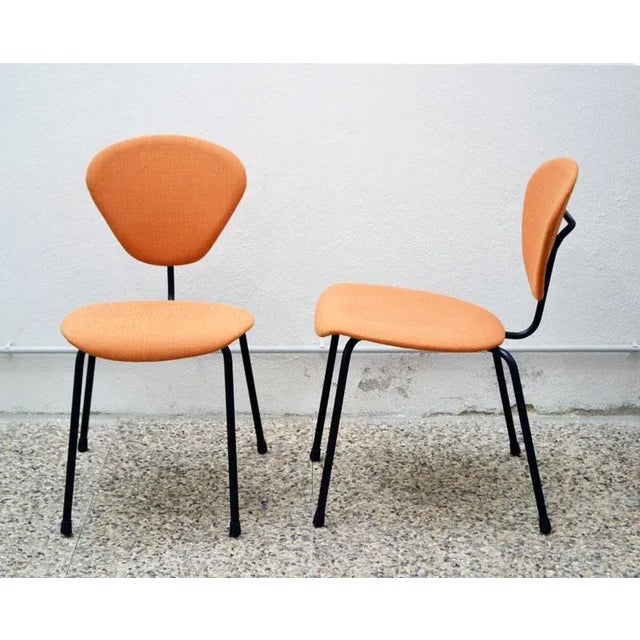 - Set of four 50s chairs with coated metal structure - Plywood seat and back upholstered with fabric - Marked with...