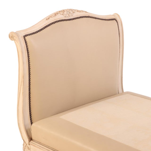 A French Louis XV-style daybed, or lit de repos, circa 1940, featuring a beautifully carved and painted wood frame...