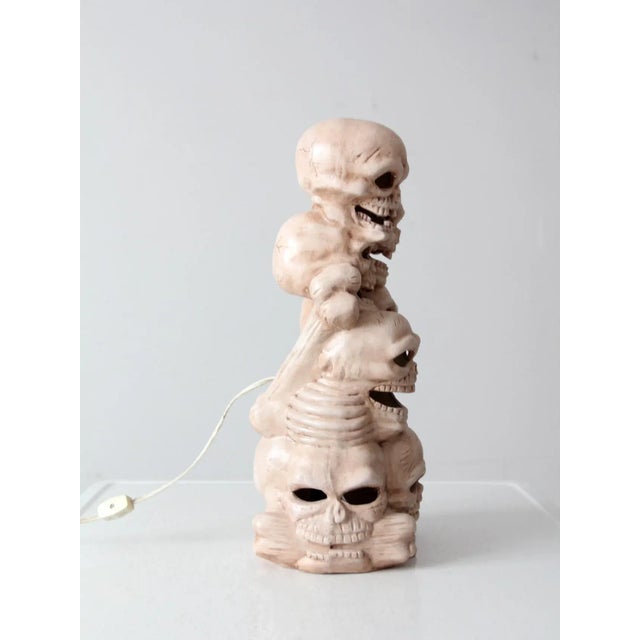 Here is a spook-tacular Halloween décor piece! This vintage ceramic stack of skulls will give your display that extra-...