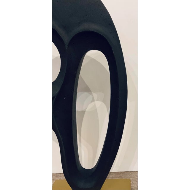 Stylish Arteriors Modern Charcoal Ricestone Kenly Sculpture, satin brass base, showroom floor sample