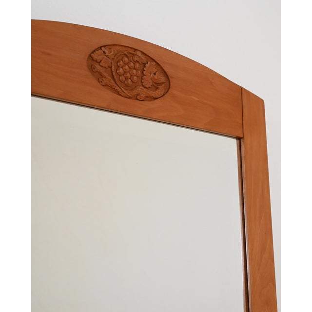 Birch frame with an arched top crosspiece and a carved medallion depicting a bunch of grapes with vine leaves. Swedish...