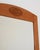 Birch frame with an arched top crosspiece and a carved medallion depicting a bunch of grapes with vine leaves. Swedish...