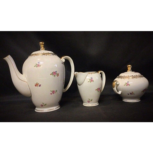 This elegant set includes a coffee pot, pitcher, and sugar bowl made from authentic porcelain by S.E.R France. Each piece...