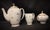 This elegant set includes a coffee pot, pitcher, and sugar bowl made from authentic porcelain by S.E.R France. Each piece...