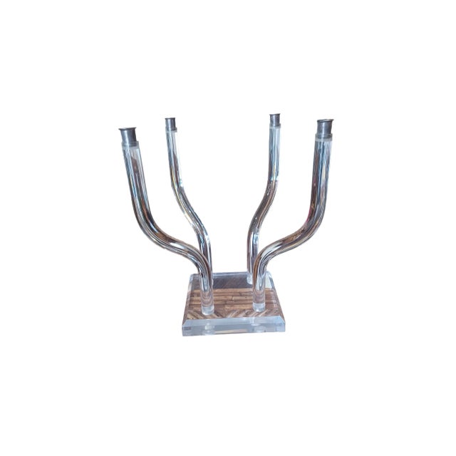 Vintage midcentury lucite candleabra with silver plated inserts. The candlebra has four arms that can be moved into...