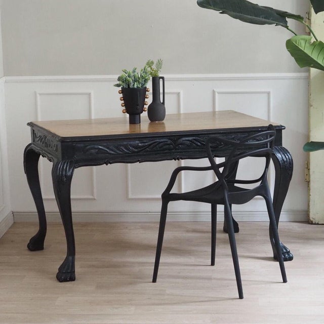 This uniquely designed dining table from the 1920s is a real eye-catcher. with its lion paws as foot legs and the black...
