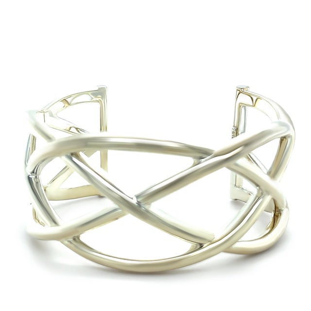 A rare vintage Tiffany & Co. Woven Celtic Knots cuff bracelet crafted in sterling silver, featuring an intricate...