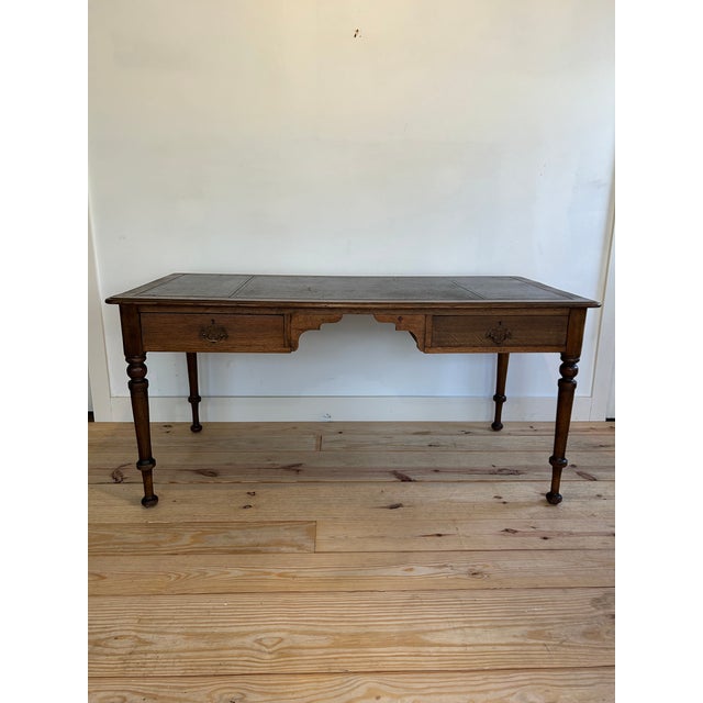 Large 19th century English white oak library desk. Original deep oxblood red leather top decorated with hand tooled...