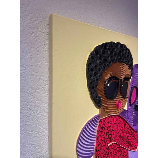 In "Plushie VI," a vibrant figure embraces a whimsical purple bear, both rendered in a playful mix of paper strips,...