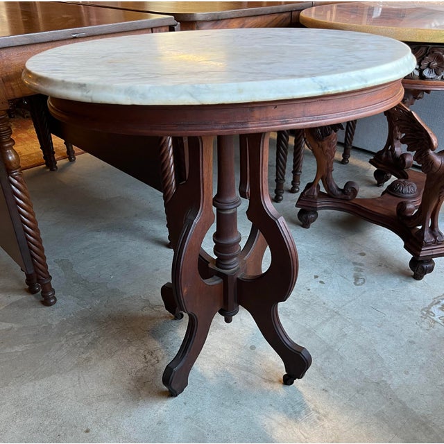 Antique Victorian marble-top table. Removable white marble-top with some light staining. Walnut base with original...