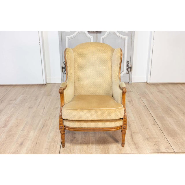 This elegant 20th century French Louis XVI style bergère, or shepherdess chair, combines timeless sophistication with...